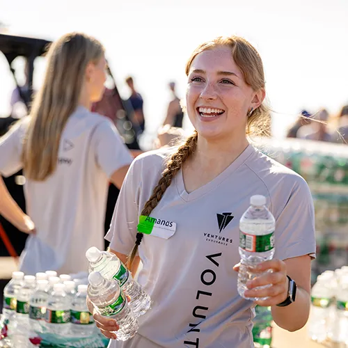 Female volunteer handing out water Female volunteer handing out water